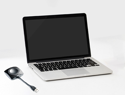 Image of a laptop with a clickshare dongle